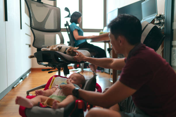 Young Asian parents/adults enjoying the benefits of working from home - getting to spend time with loved ones